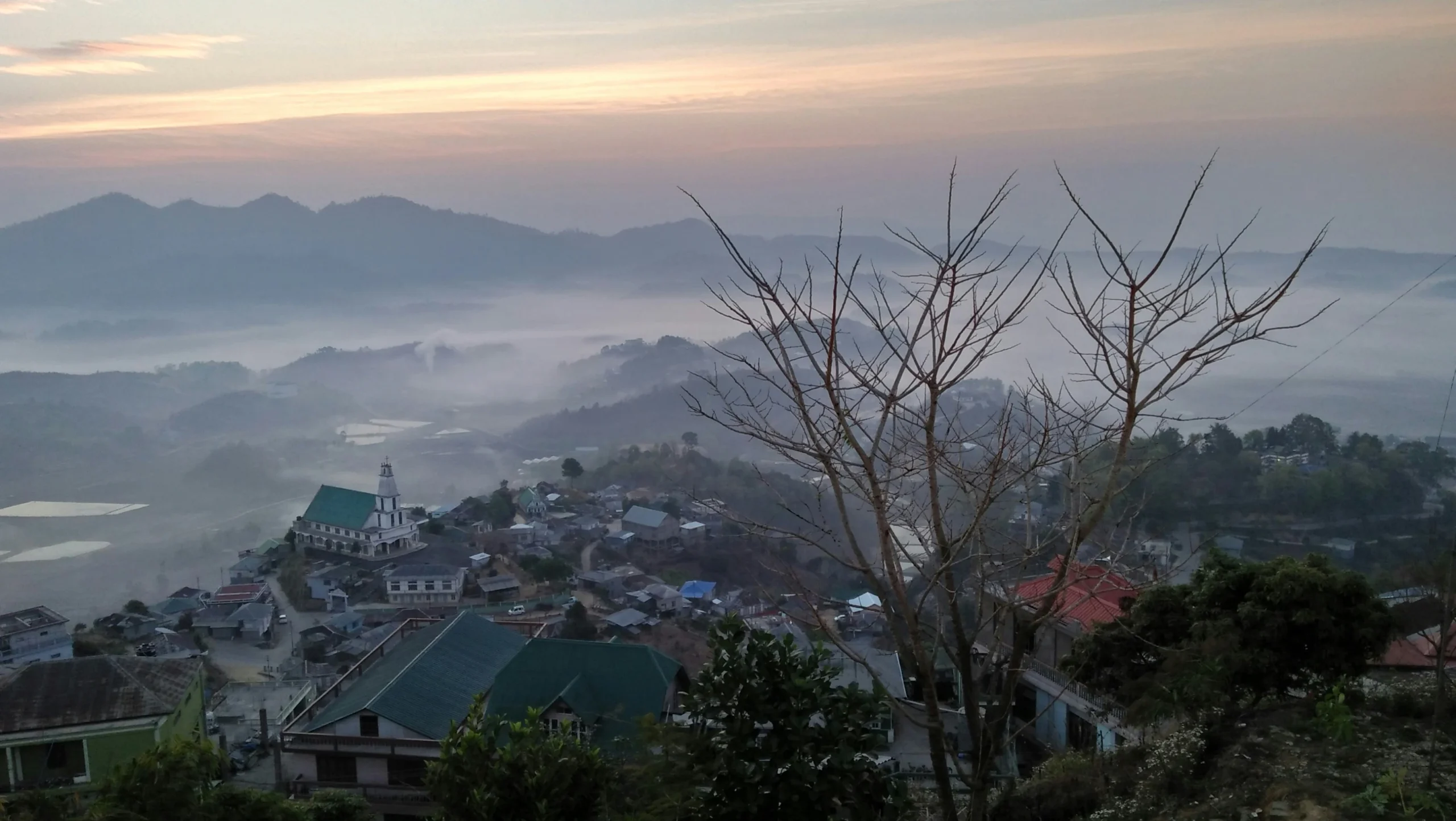 a mizo town covered in fog