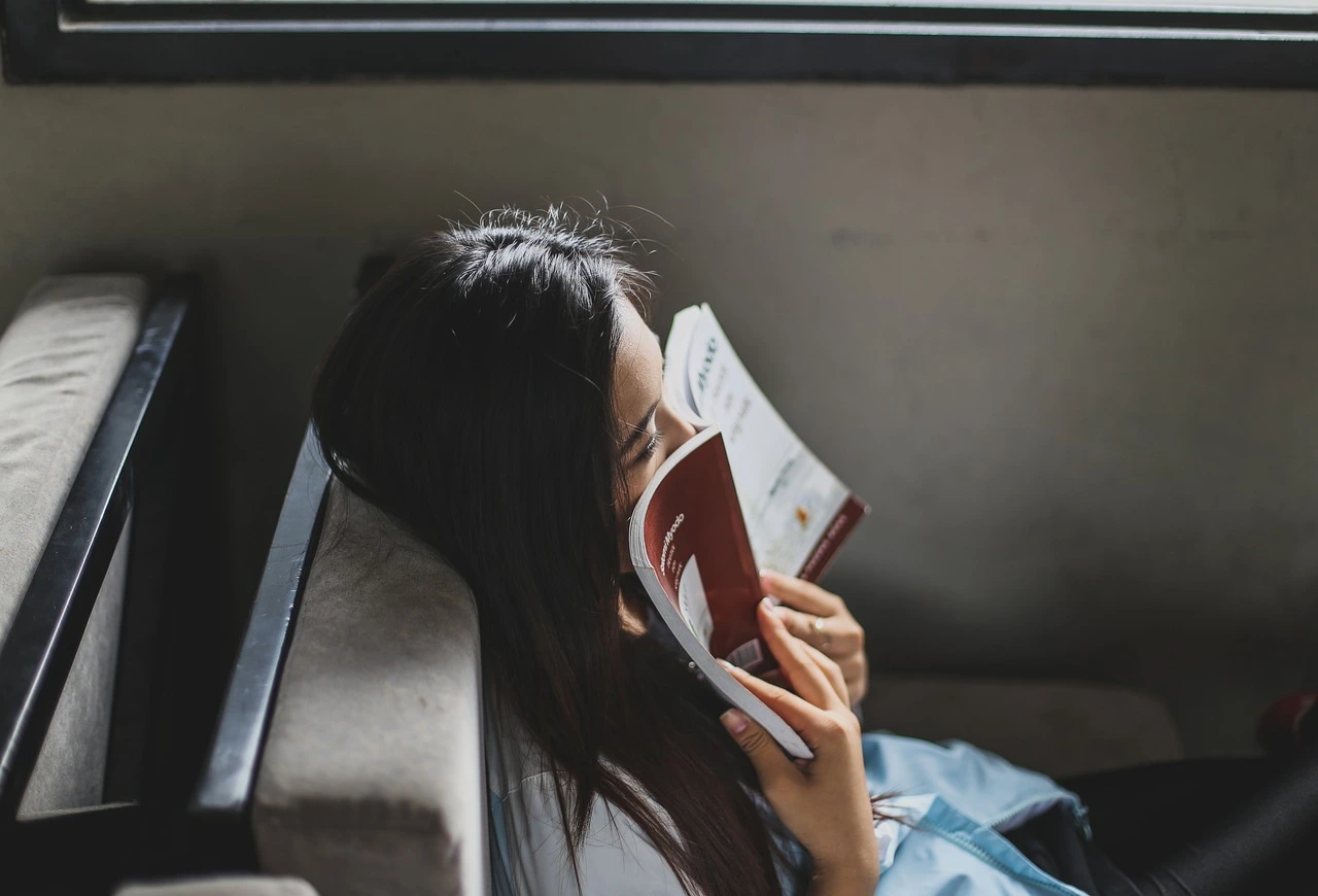 a girl with a book on her face